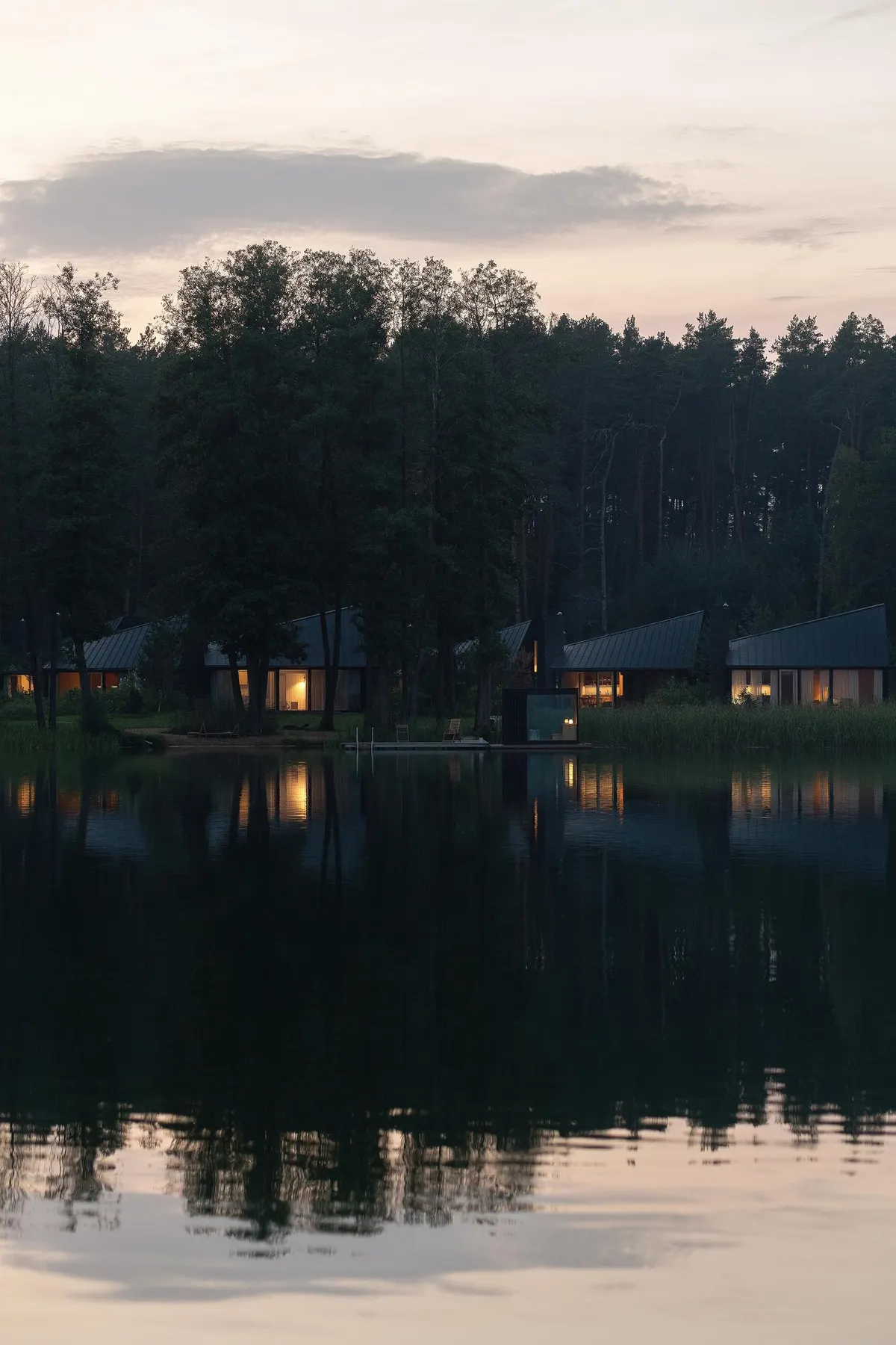 Lake at dusk with houses along the far shore